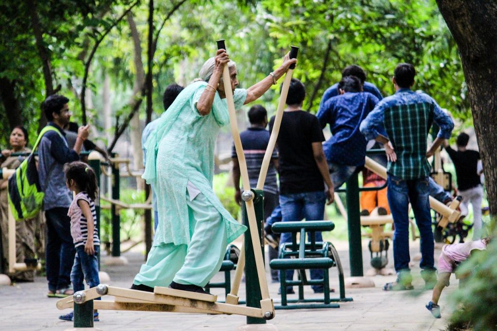An older Indian lady exercising at a public gym. There are safe ways for seniors to exercise with medical conditions.